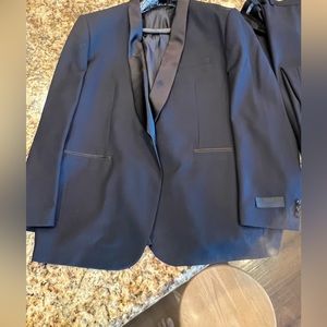 Navy blue tuxedo jacket and pants,style is Daniel Craig James Bond